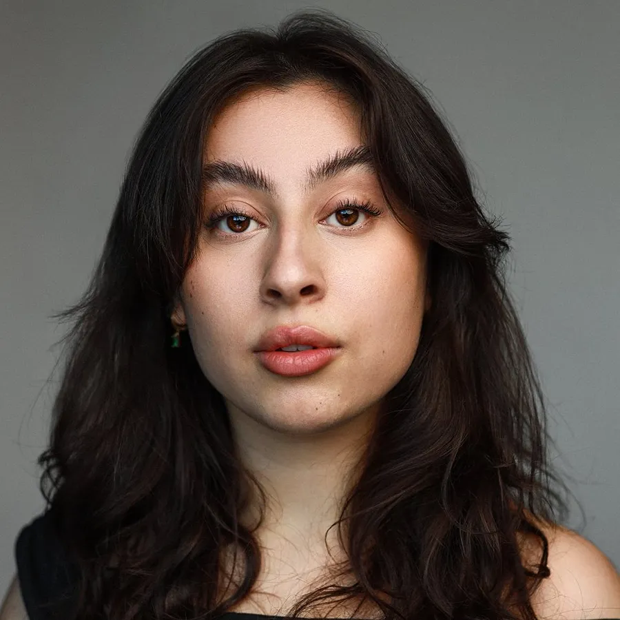 Romona Lewis-Malley cast of One Day the Musical. Headshot with long dark hair.
